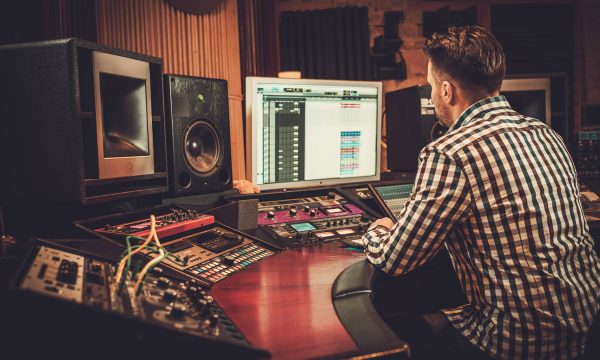 Sound engineer working in boutique recording studio. Sound engineer working in boutique recording studio