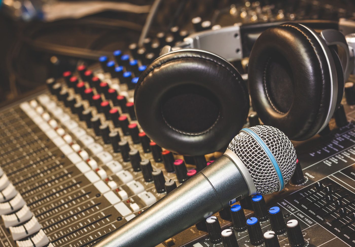 Close up instruments music background concept.Single microphone Close up instruments music background concept.Single microphone with headphones on sound mixer board in home recording studio.Free space for creative design text & wording mock up template.
